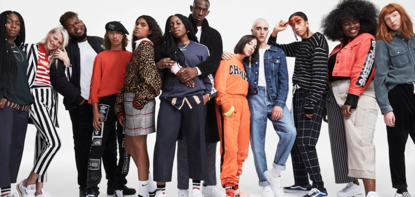 a group of people posing in front of a white background